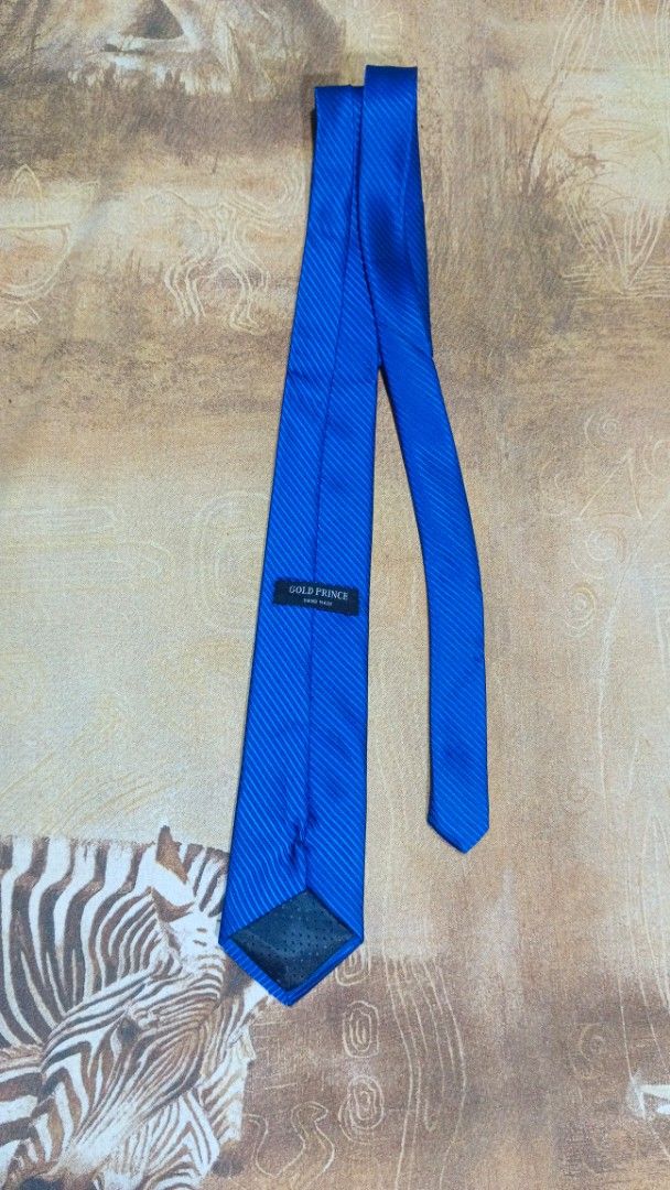 Gold Prince Blue Silk Necktie (Category: Ties) located in Cavite. Submitted by navias (Listing ID 1469396172, Image 1). Description: Origin:UAE100% - Brand: Gold Prince - Color: Bright blue - Design: Subtle diagonal ribbed texture - Build: Hand-made construction with standard width blade - Details: Black keeper loop and clean finish on the tipping - Condition: Excellent / Ready to wear Transaction Details: -via immediate same-day courier shipping