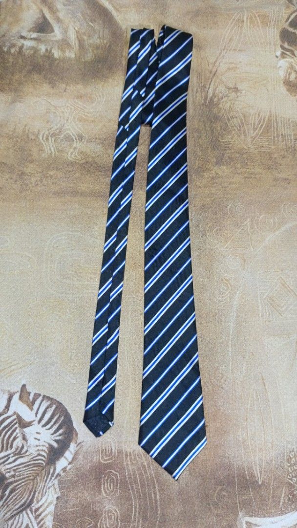 Gold Prince Hand Made Striped Tie (Category: Ties) located in Cavite. Submitted by navias (Listing ID 1469396238, Image 3). Description: Origin:UAE100% - Brand: Gold Prince (Handmade) - Design: Classic black base with diagonal white and blue stripes - Details: Clean stitching and clear brand label on the back loop - Fit: Standard width style - Styling: Easy to match with formal shirts and business suits Transaction Details: -via immediate same-da