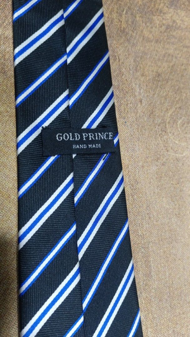 Gold Prince Hand Made Striped Tie (Category: Ties) located in Cavite. Submitted by navias (Listing ID 1469396238, Image 2). Description: Origin:UAE100% - Brand: Gold Prince (Handmade) - Design: Classic black base with diagonal white and blue stripes - Details: Clean stitching and clear brand label on the back loop - Fit: Standard width style - Styling: Easy to match with formal shirts and business suits Transaction Details: -via immediate same-da