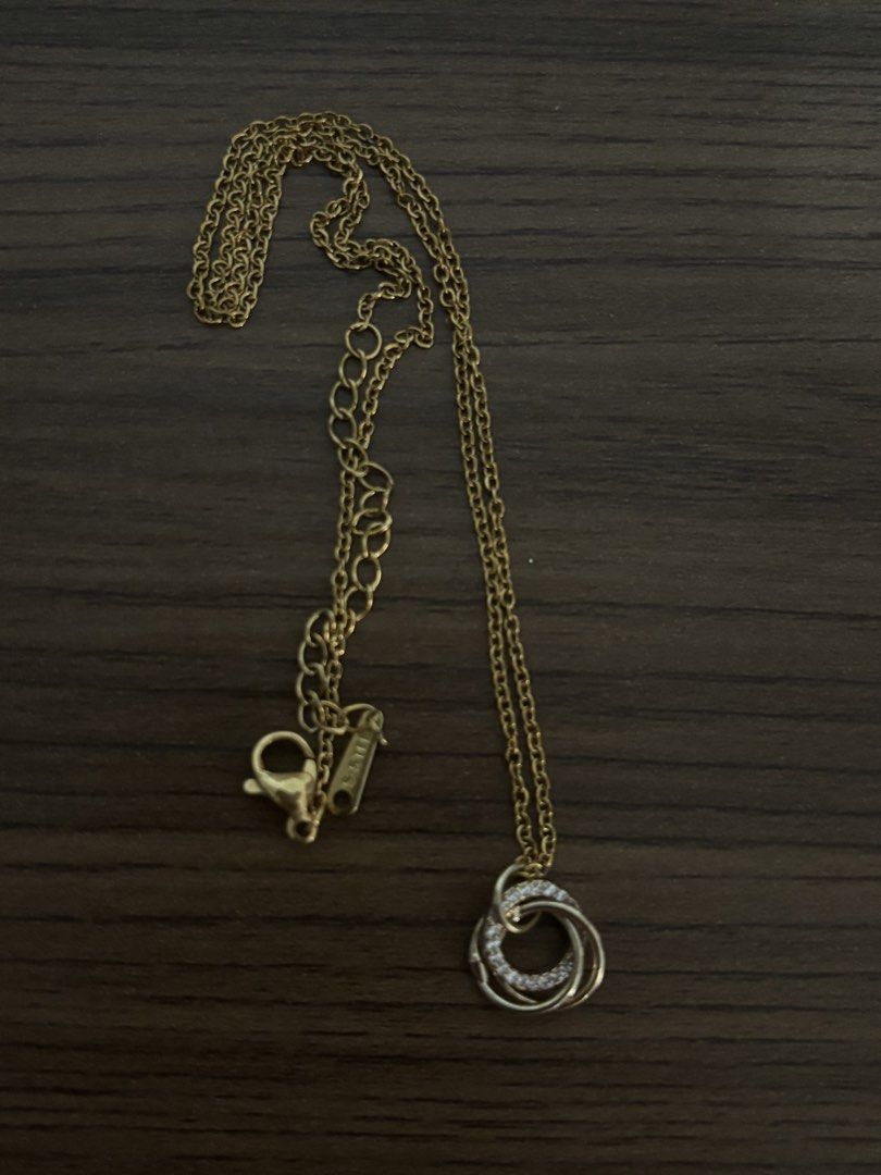 Gold-tone Interlocking Circles Pendant Necklace with Crystals (Category: Necklaces) located in San Juan City. Submitted by hellokitty_454 (Listing ID 1469475678, Image 2). Description: - Design: Gold-tone necklace featuring three interlocking circles - Detail: One circle beautifully paved with sparkling clear crystals - Material: Durable S-STEEL (marked near the clasp) - Closure: Delicate link chain with an adjustable extension and secure lobster