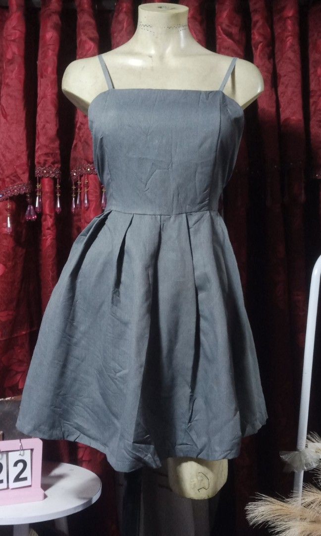 Gray mini dress (Category: Dresses) located in Manila. Submitted by wheneity67thifted (Listing ID 1469562914, Image 1). Description: The image shows a dark grey or charcoal pleated spaghetti-strap mini dress, closely resembling styles like the frunco Apron Dress or similar Korean-insfired. fit-and-flare designs..