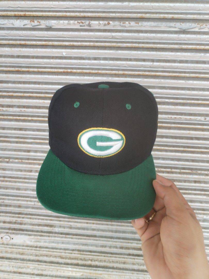 Green Bay Packers Snapback Cap (ukay Bootleg hat) (Category: Caps & Hats) located in Naga. Submitted by basejohnpa64527 (Listing ID 1469483539, Image 1). Description: - Authentic Green Bay Packers snapback cap - Stylish black crown with contrasting green brim and eyelets - Raised embroidered team logo on the front - Official NFL logo patch on the left side - Adjustable plastic snap closure for a custom fit - Finished with interior taped seams and