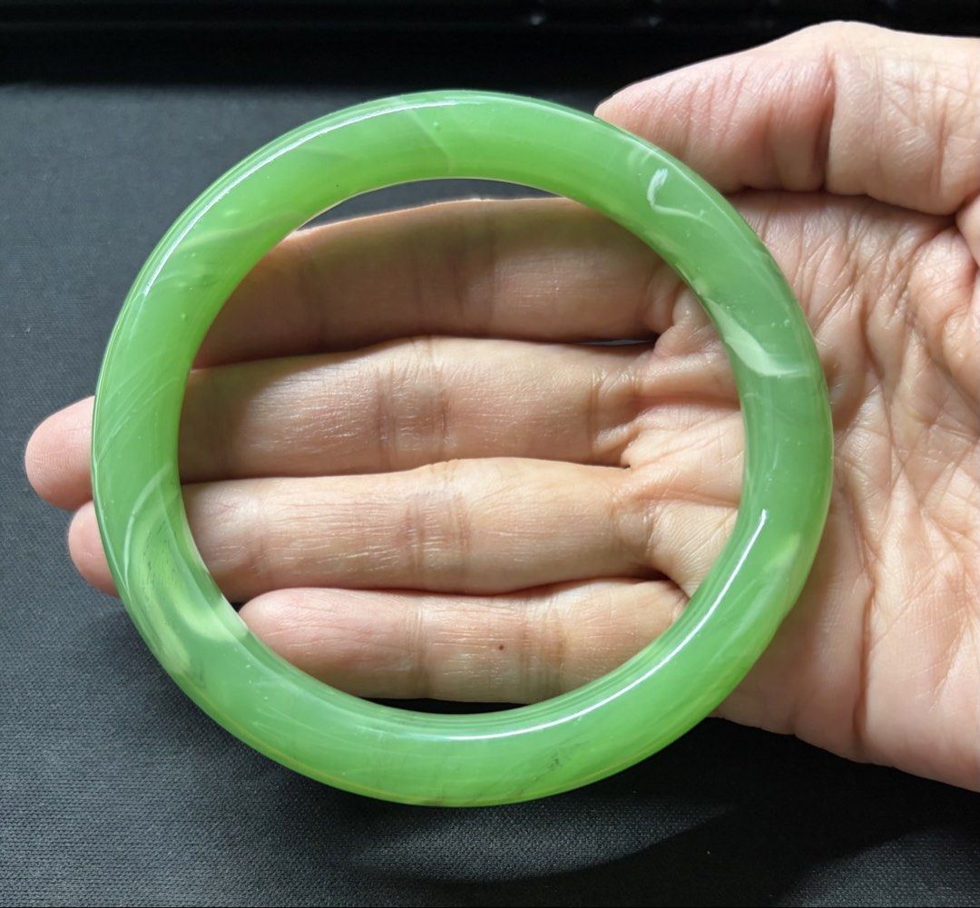 Green Jade Bangle Bracelet (Category: Bracelets) located in Quezon City. Submitted by garagesale2026 (Listing ID 1469554220, Image 3). Description: - Vibrant green jade with natural white marbling and cloud patterns - Smooth polished finish with a high-gloss shine - Inner diameter: approximately 60mm - From Hong Kong.