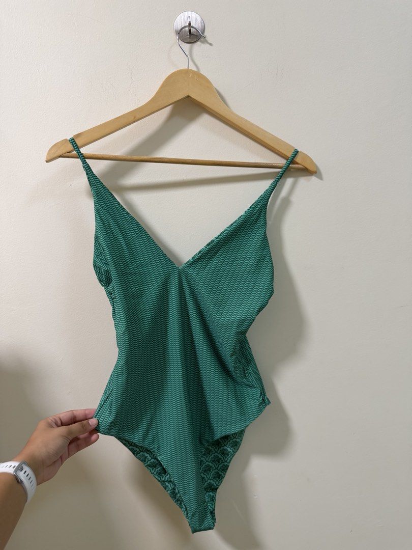 Green Reversible One-Piece Swimsuit Patterned (Category: Bikinis & Swimsuits) located in Makati City. Submitted by andzr. (Listing ID 1469543107, Image 3). Description: - Style: Reversible one-piece swimsuit (2-in-1 design) - Color/Design: Green with a patterned print on one side and a wave pattern on the reverse - Features: V-neckline with thin adjustable straps - Condition: Brand new with tags still attached - Ideal for: Beach trips, vacations,