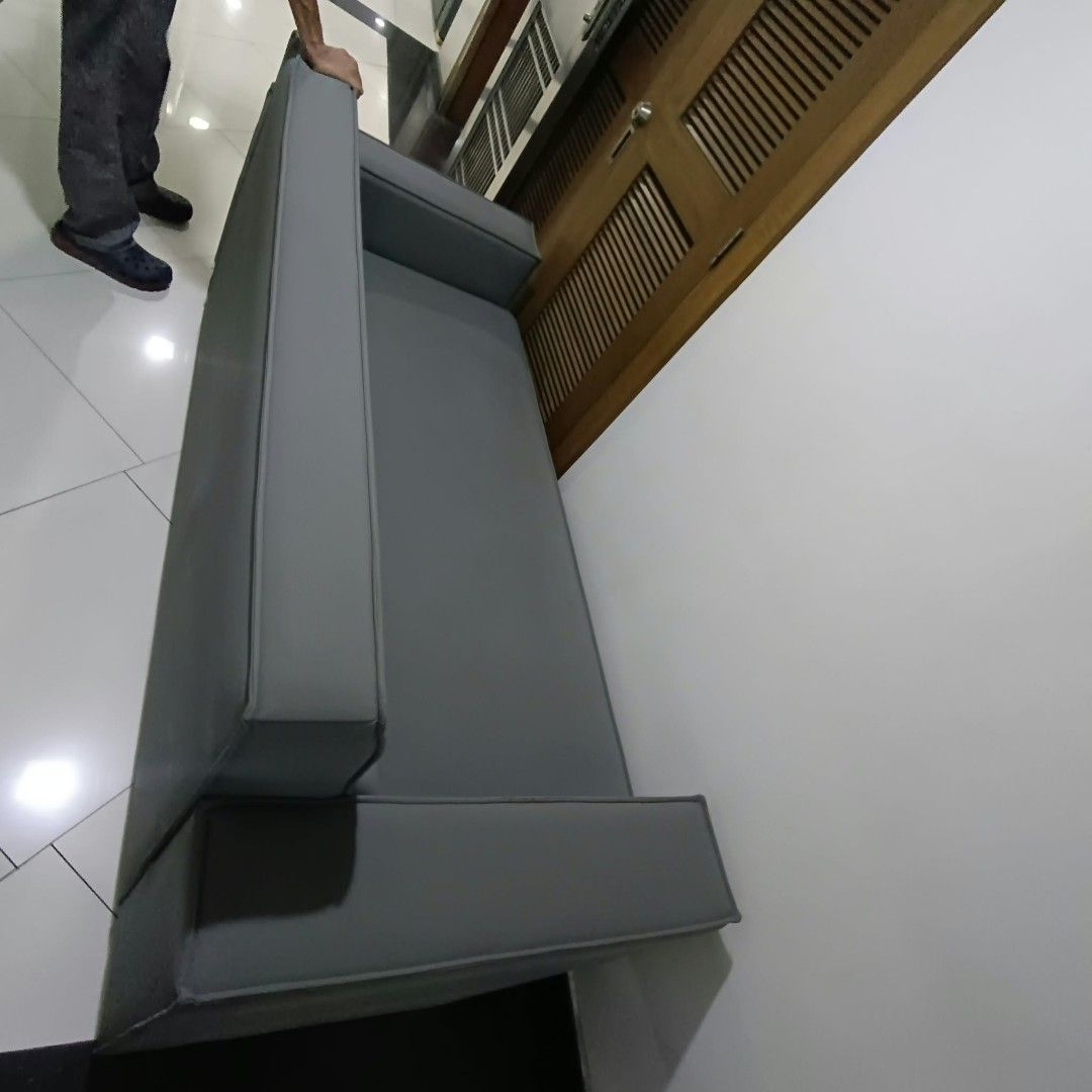 Grey Leather Sofa Couch (Category: Sofas) located in Manila. Submitted by yorkie112643153 (Listing ID 1469482080, Image 1). Description: NAPAKA PRESENTABLE PO NITO NAGPALIT LANG NG MAS MALAKI PARA SA CONDO BINONDO MANILA - Modern grey faux leather couch suitable for living rooms or offices - Features straight armrests, attached back cushions, and a solid, sturdy build - Condition: Some peeling and wear along the piping seam near the backrest cush
