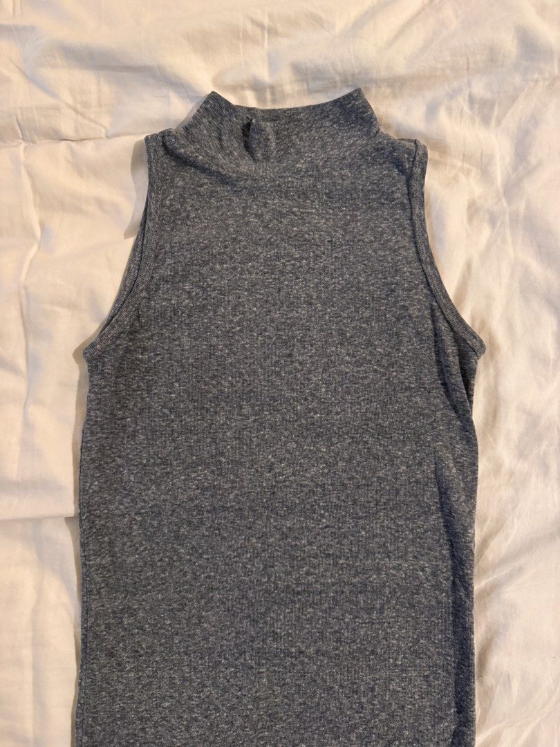 Grey Mock Neck Sleeveless Ribbed Knit Top (Category: Sleeveless) located in Quezon City. Submitted by ianne.declutter (Listing ID 1469437173, Image 1). Description: - Color: Heathered dark grey - Style: Sleeveless top with high mock neckline - Fabric: Comfortable ribbed knit - Fit: Slim fit cut - Versatility: Great basic for layering or pairing with jeans and shorts.