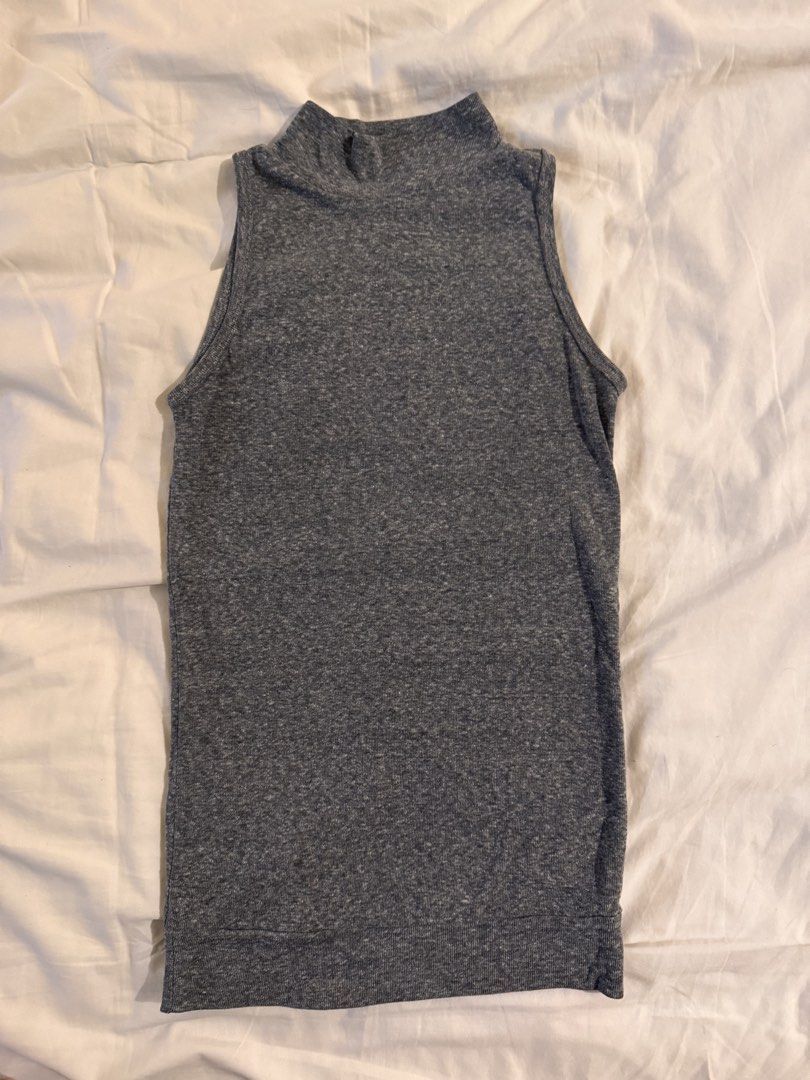 Grey Mock Neck Sleeveless Ribbed Knit Top (Category: Sleeveless) located in Quezon City. Submitted by ianne.declutter (Listing ID 1469437173, Image 2). Description: - Color: Heathered dark grey - Style: Sleeveless top with high mock neckline - Fabric: Comfortable ribbed knit - Fit: Slim fit cut - Versatility: Great basic for layering or pairing with jeans and shorts.