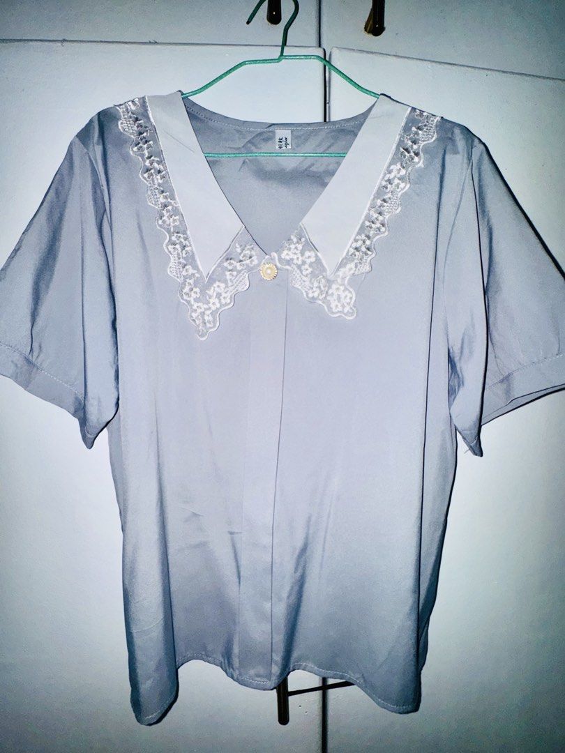 Grey Short Sleeve Blouse with White Lace Collar (Category: Blouses) located in Valenzuela. Submitted by styledtwicethriftshop (Listing ID 1469489335, Image 2). Description: Grey short sleeve blouse with a chic white lace-trim lapel and a pearl button. Lightweight, comfortable, and perfect for both casual days and the office. Fits relaxed and looks effortlessly stylish..
