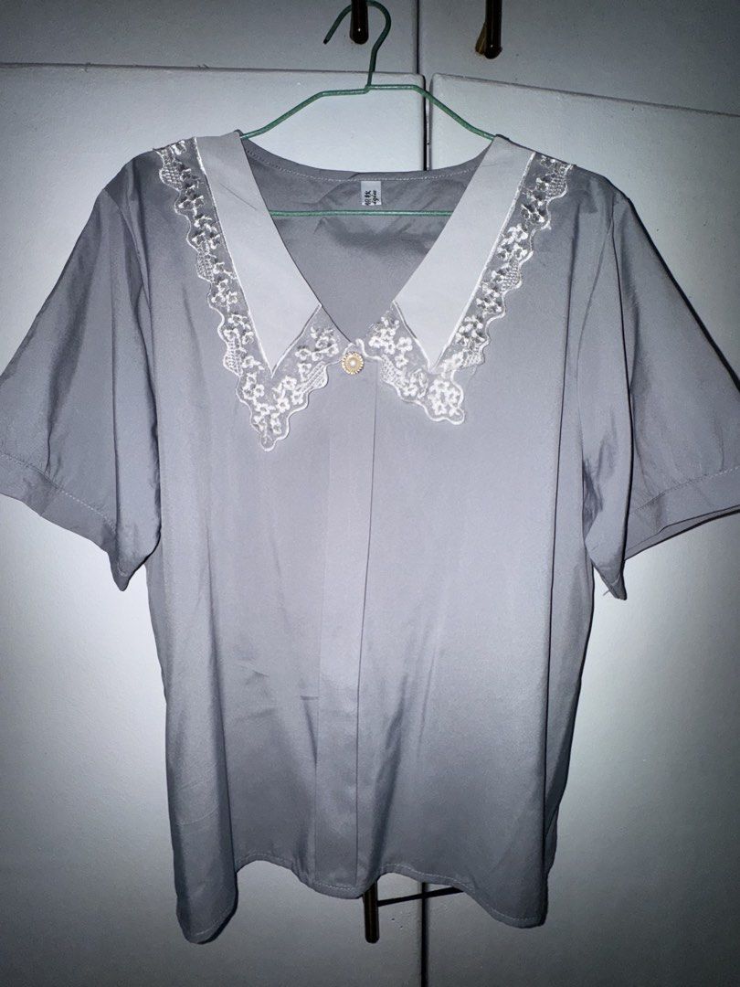 Grey Short Sleeve Blouse with White Lace Collar (Category: Blouses) located in Valenzuela. Submitted by styledtwicethriftshop (Listing ID 1469489335, Image 1). Description: Grey short sleeve blouse with a chic white lace-trim lapel and a pearl button. Lightweight, comfortable, and perfect for both casual days and the office. Fits relaxed and looks effortlessly stylish..