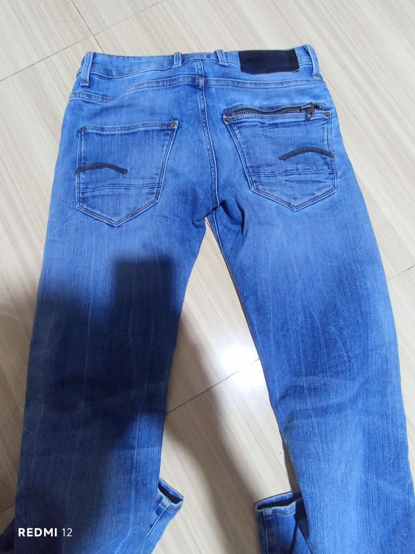 G-Star RAW Blue Denim Jeans (Category: Jeans) located in Sariaya. Submitted by angelochintes732 (Listing ID 1469462048, Image 1). Description: - Brand: G-Star RAW - Color/Wash: Medium blue with stylish faded details - Closure: Button fly with branded metal buttons - Pockets: Classic 5-pocket styling featuring a unique zipper detail on the back pocket - Details: Black leather logo patch on the back waistband - Fit: Comfortable fit for all-day wear