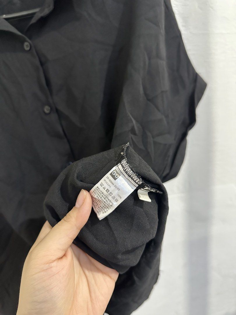 GU Black Oversized Short Sleeve Button Down Blouse Size XL (Category: Shirts) located in San Jose del Monte. Submitted by bizzybeebyhgc (Listing ID 1469437621, Image 2). Description: - Brand/Model: GU black button-down blouse - Size: XL (Relaxed, oversized fit) - Material: 100% lightweight polyester - Features: Short sleeves with rolled cuffs, collared neck, full front button placket, and back pleat detail - Style: Simple and versatile, perfect f