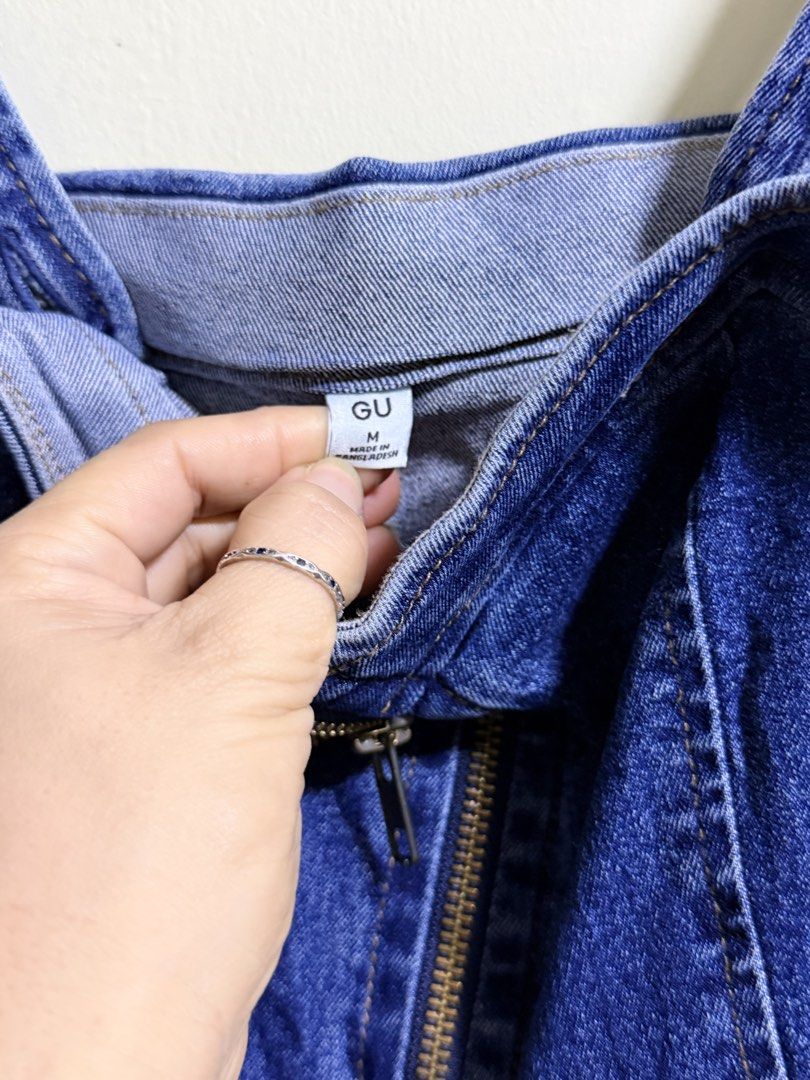 GU Blue Denim Midi Dress Front Zip Size M (Category: Dresses) located in Paete. Submitted by skydruemadison (Listing ID 1469496539, Image 2). Description: - Brand: GU - Style: Denim midi dress with straight cut skirt - Color/Wash: Dark blue - Size: M (Made in Bangladesh) - Closure: Full front metal zipper - Features: Built-in side pockets, fitted bodice with structured seams, adjustable straps, and elastic upper back panel - Fabric: Comfortable w