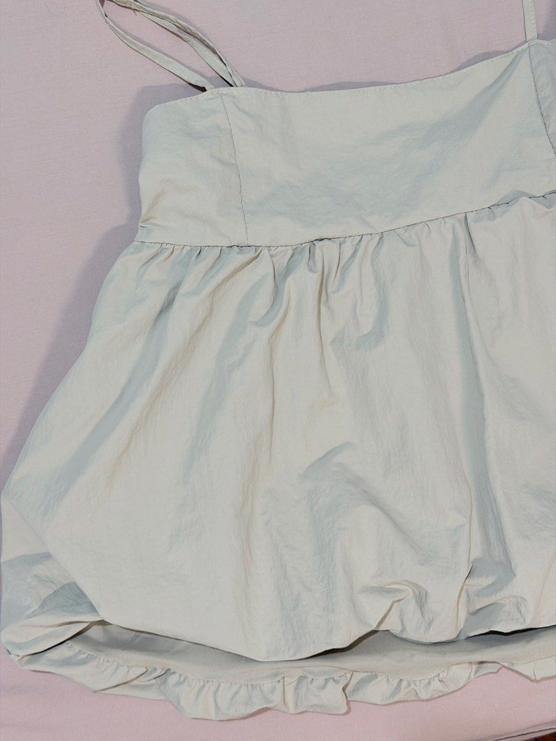 GU Bubble Hem Camisole Top Light Green Size L (Category: Sleeveless) located in Paranaque City. Submitted by hannahking36 (Listing ID 1469538656, Image 2). Description: - Brand: GU - Size: L - Color: Light green - Style: Babydoll camisole with a bubble hem - Features: Adjustable double straps, open back design, and a comfortable elastic back band - Material: Lightweight and breathable - Condition: Great, worn only a couple of times - Styling tip: