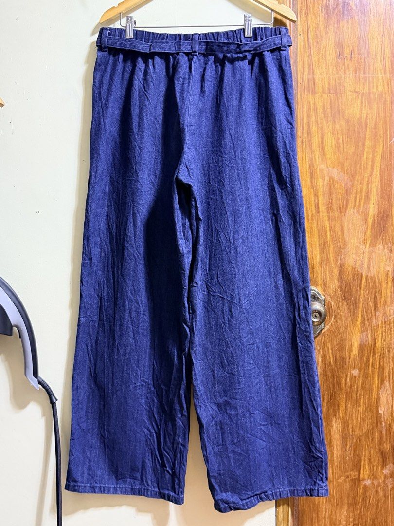 GU Denim Blue Convertible Pants Overalls (Category: Jumpsuits) located in Paete. Submitted by skydruemadison (Listing ID 1469497511, Image 2). Description: - Brand: GU - Style: 2-in-1 convertible denim pants and overalls with removable shoulder straps - Wash: Deep blue wash - Fit: Wide leg fit with adjustable waist tie belt - Comfort: Elastic waistband at the back for a comfy fit - Versatility: Can be worn as regular high-waisted pants or as over