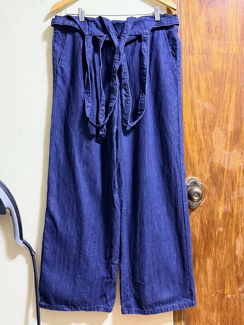 GU Denim Blue Convertible Pants Overalls (Category: Jumpsuits) located in Paete. Submitted by skydruemadison (Listing ID 1469497511, Image 1). Description: - Brand: GU - Style: 2-in-1 convertible denim pants and overalls with removable shoulder straps - Wash: Deep blue wash - Fit: Wide leg fit with adjustable waist tie belt - Comfort: Elastic waistband at the back for a comfy fit - Versatility: Can be worn as regular high-waisted pants or as over
