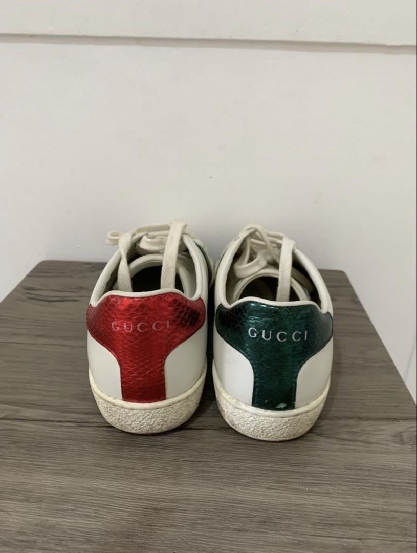 Gucci Ace Sneakers White Size 36 (Category: Sneakers) located in Dumaguete. Submitted by freshcornerbyyeng (Listing ID 1469412505, Image 3). Description: - Brand: Gucci Ace Sneakers - Color: White leather with Green and Red Web stripe - Size: 36 - Details: Metallic mismatch heel counters in red and green with embossed Gucci lettering, white laces - Condition: Pre-loved, showing minor leather creasing and dirt/wear on the soles - Style: Classic lo