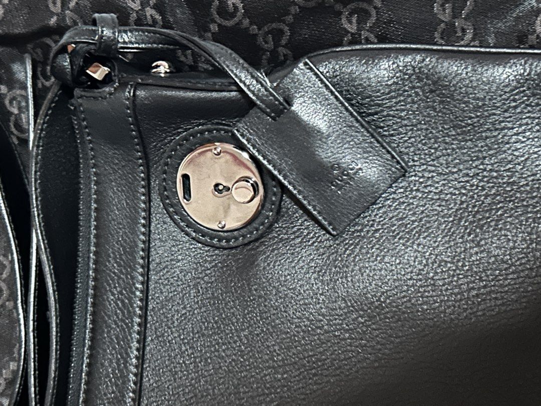 Gucci Black Leather Handbag with Lock Hardware (Category: Luxury Bags & Wallets) located in Manila. Submitted by campnks (Listing ID 1469451290, Image 3). Description: - Brand: Gucci - Color: Classic Black - Material: Soft textured leather grain with clean, durable stitching - Hardware: Sleek silver-tone hardware - Special Features: Includes matching leather luggage tag and unique circular lock mechanism detail on the front - Strap: Conveniently 