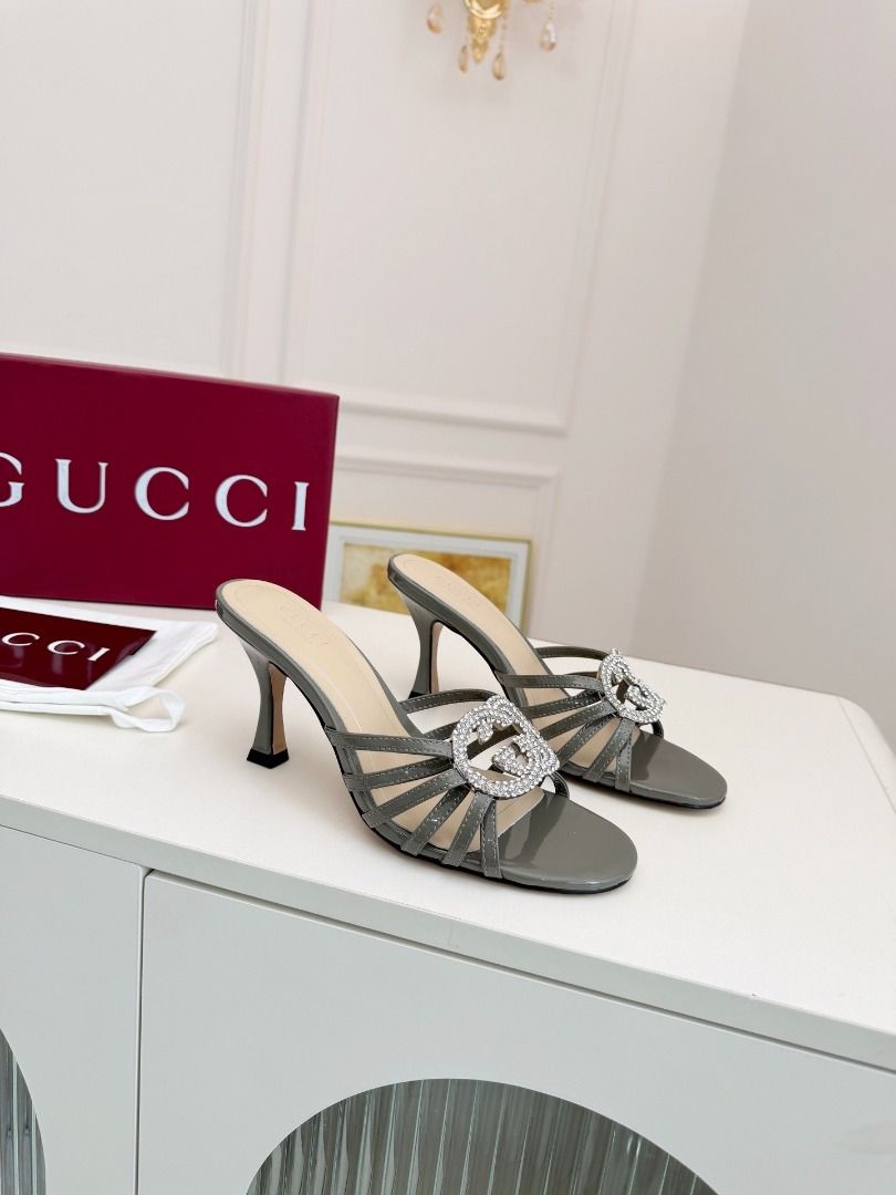 Gucci Crystal Interlocking G Mules Heels Grey(High-end custom model） (Category: Heels) located in Pasay City. Submitted by thesky-- (Listing ID 1469469709, Image 1). Description: - Brand: Gucci - Style: High heel mules with strappy front and stiletto heels - Material: Grey patent leather - Detail: Rhinestone-encrusted interlocking G logo - Inclusions: Original box and dust bag included - Note: Other colors available, feel free to ask!.