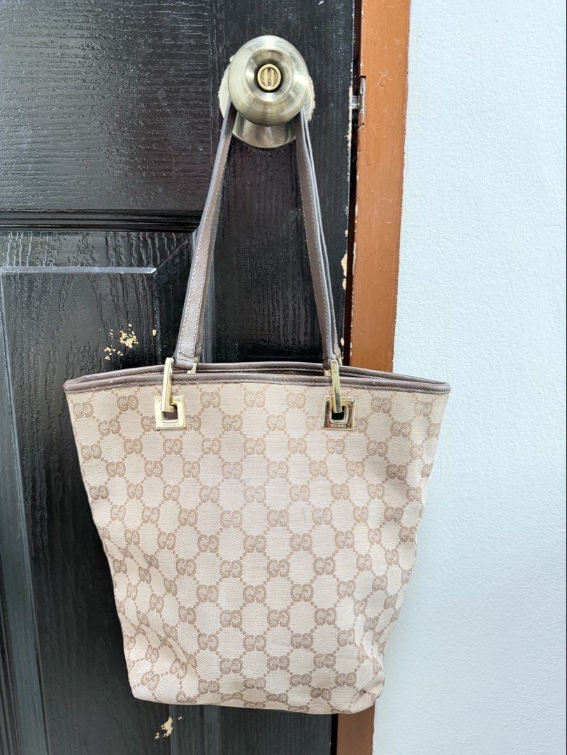 Gucci GG Canvas Mini Tote Bag (Category: Luxury Bags & Wallets) located in Marikina City. Submitted by periwinklestore88 (Listing ID 1469354522, Image 1). Description: - Authentic Gucci GG canvas tote bag in classic brown - Premium leather trim and sturdy dual straps - Elegant gold-tone hardware with engraved Gucci lettering - Clean dark fabric interior with a secure zipped pocket - Features the official 'Gucci made in Italy' leather stamp - Spac