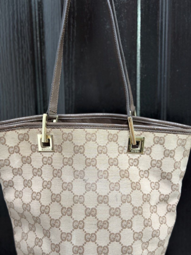 Gucci GG Canvas Mini Tote Bag (Category: Luxury Bags & Wallets) located in Marikina City. Submitted by periwinklestore88 (Listing ID 1469354522, Image 2). Description: - Authentic Gucci GG canvas tote bag in classic brown - Premium leather trim and sturdy dual straps - Elegant gold-tone hardware with engraved Gucci lettering - Clean dark fabric interior with a secure zipped pocket - Features the official 'Gucci made in Italy' leather stamp - Spac