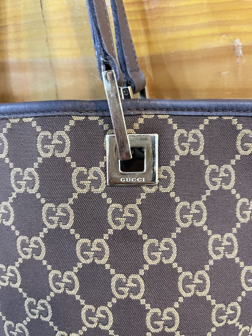 Gucci GG Canvas Tote Bag (Category: Tote Bags) located in Baguio. Submitted by elcie.08 (Listing ID 1469475567, Image 3). Description: - Authentic Gucci GG monogram canvas tote in classic brown - Dark brown leather trim and comfortable dual top handles - Elegant square hardware accents stamped with the brand name - Clean fabric interior lining with a zipped pocket - Includes classic leather heat stamp tag with serial numbers - Spacious and stylis