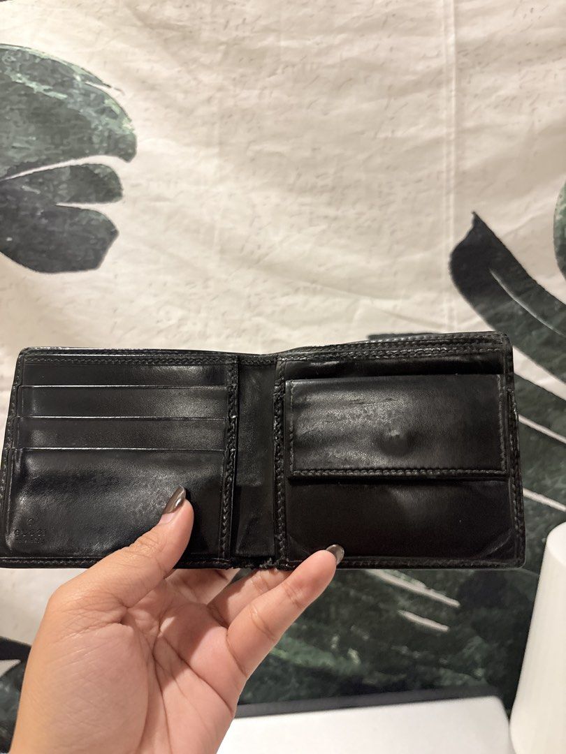 AUTHENTIC Gucci GG Monogram Black Bifold Wallet (Category: Luxury Bags & Wallets) located in Caloocan City. Submitted by fierce_mica29 (Listing ID 1469503383, Image 3). Description: - Authentic black Gucci bifold wallet - Iconic glossy GG monogram exterior - Interior includes multiple card slots, slip pocket, and snap coin pouch - Serial number stamped inside for authenticity - Condition: Shows normal signs of handling and use on the leather inte