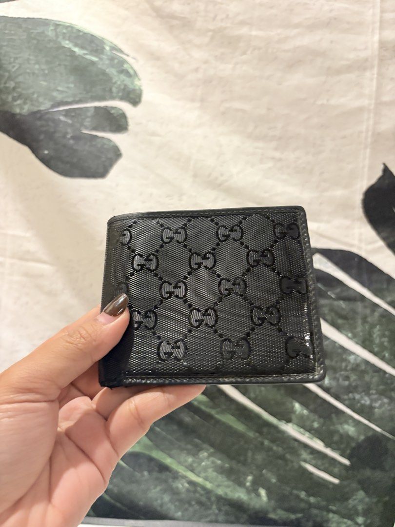 AUTHENTIC Gucci GG Monogram Black Bifold Wallet (Category: Luxury Bags & Wallets) located in Caloocan City. Submitted by fierce_mica29 (Listing ID 1469503383, Image 1). Description: - Authentic black Gucci bifold wallet - Iconic glossy GG monogram exterior - Interior includes multiple card slots, slip pocket, and snap coin pouch - Serial number stamped inside for authenticity - Condition: Shows normal signs of handling and use on the leather inte
