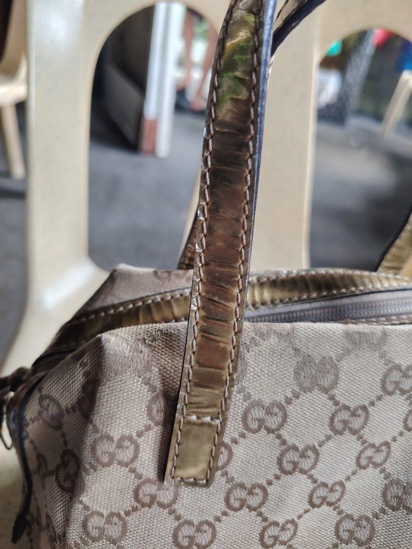 Gucci GG Monogram Canvas Gold Trim Mini Handbag (Category: Luxury Bags & Wallets) located in Manila. Submitted by tabuzomaria1422 (Listing ID 1469411392, Image 3). Description: - Brand: Gucci - Material: Classic GG monogram canvas with metallic gold leather trim - Closure: Secure top zipper with gold pull tab - Interior: Patterned fabric lining with brand patch - Features: Dual top handles, compact structured shape for everyday essentials - Condi