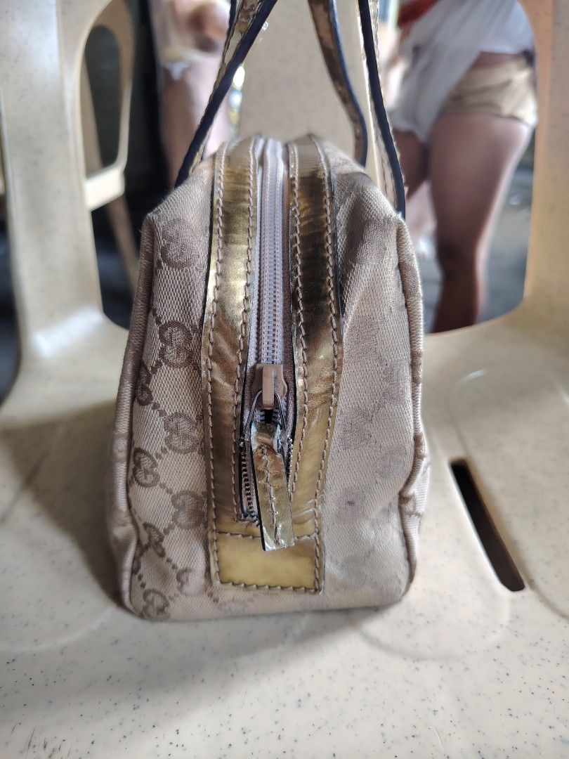 Gucci GG Monogram Canvas Gold Trim Mini Handbag (Category: Luxury Bags & Wallets) located in Manila. Submitted by tabuzomaria1422 (Listing ID 1469411392, Image 2). Description: - Brand: Gucci - Material: Classic GG monogram canvas with metallic gold leather trim - Closure: Secure top zipper with gold pull tab - Interior: Patterned fabric lining with brand patch - Features: Dual top handles, compact structured shape for everyday essentials - Condi