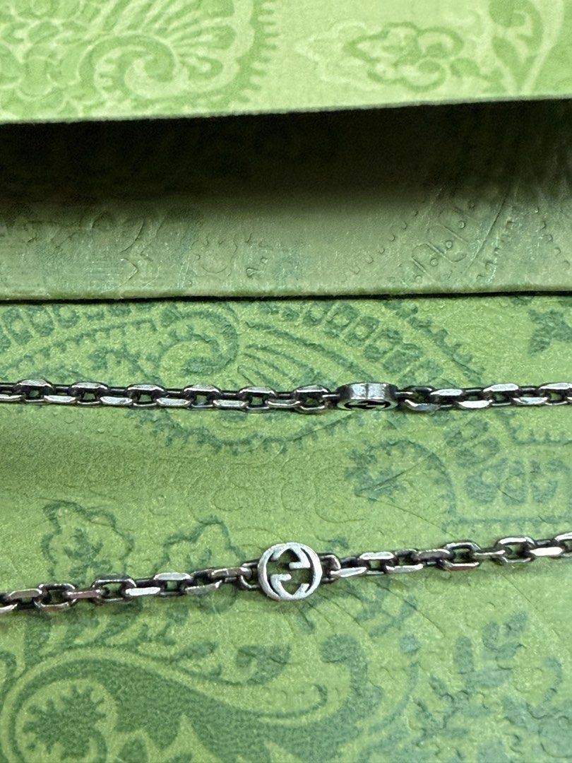 Gucci heart charm link bracelet with box (Category: Bracelets) located in Quezon City. Submitted by ellamenopi (Listing ID 1469398285, Image 3). Description: - Brand: Gucci - Material: Silver-tone metal - Design: Heart-shaped pendant with engraved GG detail and Interlocking G logos along the chain - Closure: Secure lobster clasp - Inclusion: Original green patterned Gucci box and matching cards - Condition: Excellent/Pristine - Mode of Payment: B