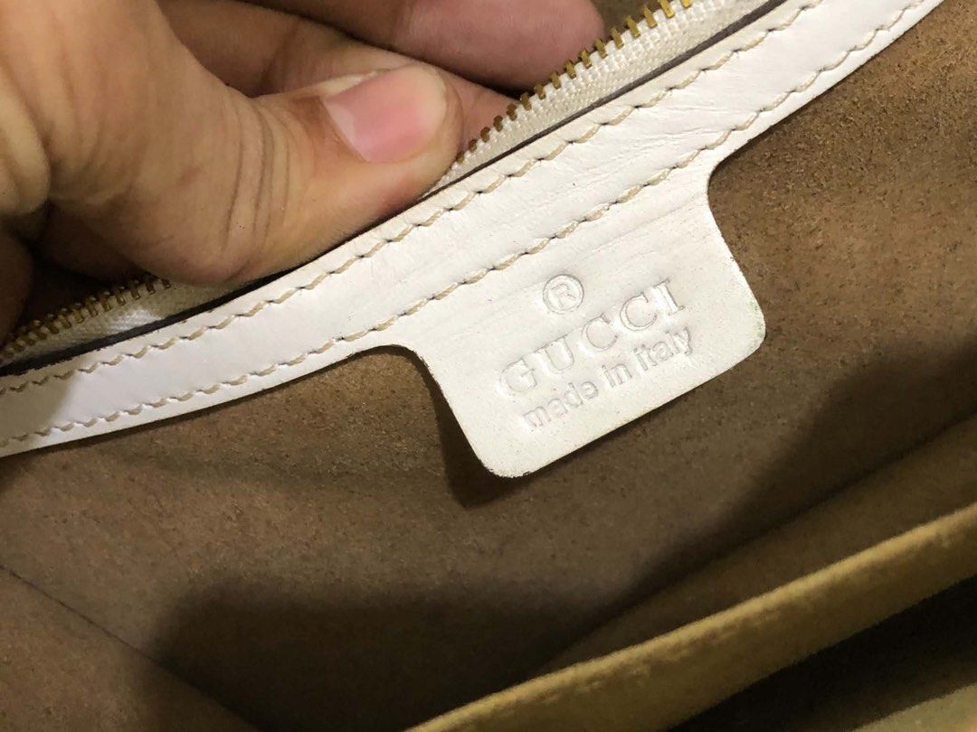 Gucci Sylvie White Leather Shoulder Bag (Category: Luxury Bags & Wallets) located in Bacolod City. Submitted by novymaesel14868 (Listing ID 1469397424, Image 3). Description: - Brand: Gucci - Model: Sylvie Shoulder Bag - Color: White leather with signature red and blue web stripe - Hardware: Gold-tone chain hardware and buckle closure - Interior: Fabric-lined with convenient zip pocket - Strap: Includes the classic striped shoulder strap - Condit