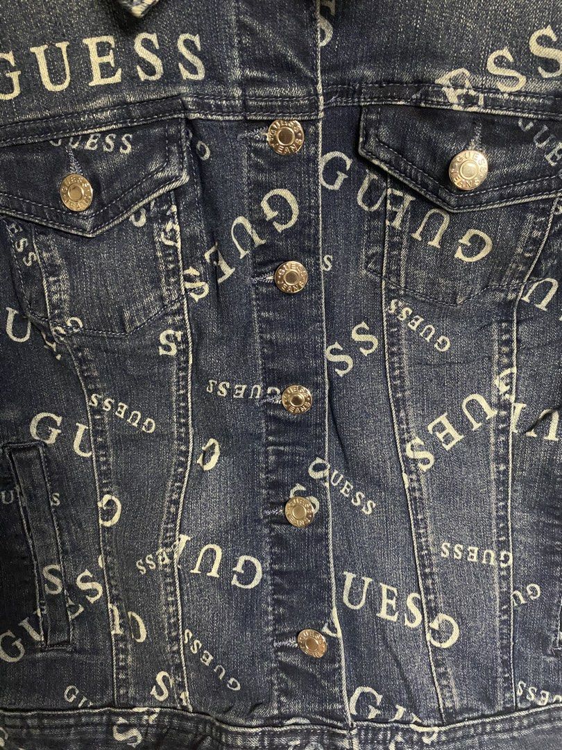 GUESS All-Over Logo-Print Denim Trucker Jacket (Category: Coats, Jackets and Outerwear) located in Cabuyao City. Submitted by ukaythriftshirt (Listing ID 1469420356, Image 2). Description: GUESS All-Over Logo-Print Denim Trucker Jacket Excellent Condition Small to Medium Dimes 21-20.5 Color rate 9/10 No issue - Mine 1k Cabuyao Laguna.