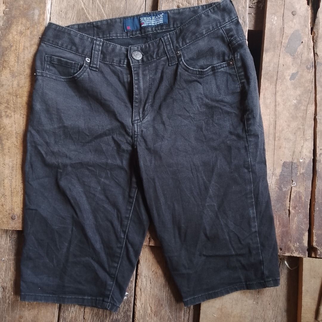 Guess Black Denim Shorts Size 26 (Category: Shorts) located in Caloocan City. Submitted by alfepangasate1021 (Listing ID 1469439426, Image 2). Description: - Brand: Guess - Color: Washed black - Size: 70 (approx. US 26) - Fit: Mid-rise with standard button and zip closure - Style: Classic 5-pocket setup with iconic Guess triangle logo on the back pocket - Details: Branded leather patch on rear waistband - Material: 80% cotton, 19% polyester, 1% s