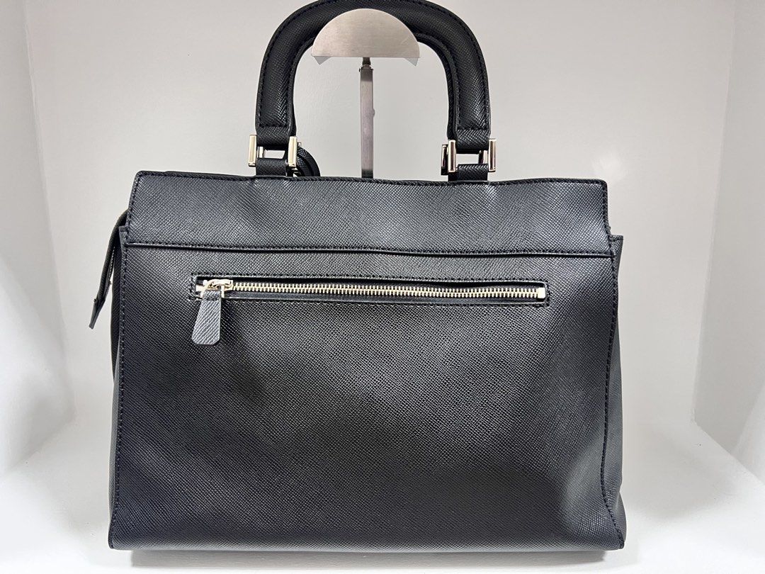 Guess Black Structured Handbag Saffiano Leather (Category: Luxury Bags & Wallets) located in San Jose del Monte. Submitted by itstokyotokyo (Listing ID 1469394279, Image 2). Description: Zalora Bought / As Is Where Is✨ / 9/10 - Brand: Guess - Color: Black with silver hardware - Material: Durable Saffiano textured material - Closure: Zippered main compartment - Pockets: External back zip pocket and interior organizational pockets - Handles: Dual t