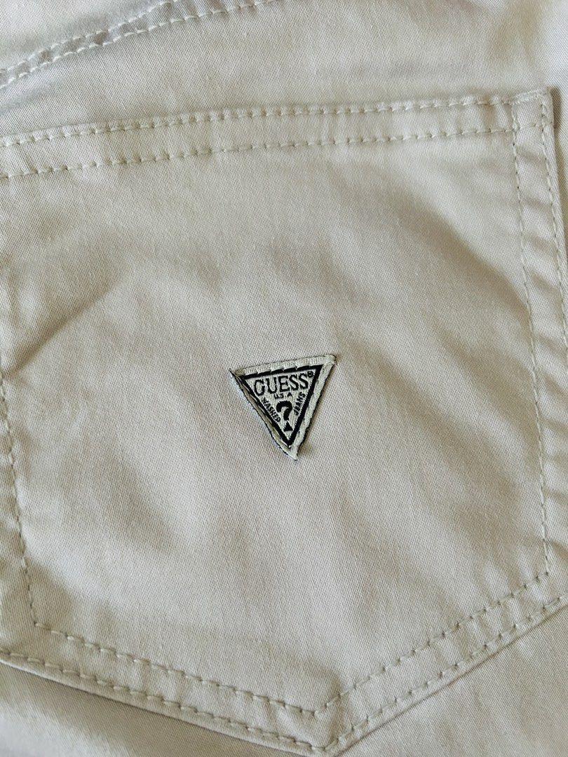 Guess Los Angeles Beige Pants Size 8 (Category: Babies & Kids Fashion) located in Batangas. Submitted by lucasvivie01983 (Listing ID 1469416331, Image 3). Description: - Brand: Guess - Color: Beige - Size: Tagged Size 8 - Fit: Straight leg cut - Style: Classic five-pocket design with button closure and belt loops - Details: Signature embroidered Guess triangle logo patch on the back pocket - Condition: Clean fabric, excellent ready-to-wear condit