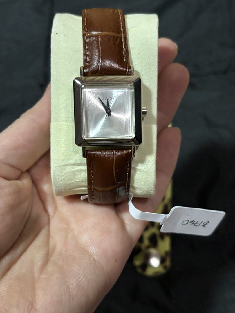 Guess Square Dial Watch with Brown Leather Strap (Category: Women's Watches) located in Caloocan City. Submitted by berndale_closet (Listing ID 1469570620, Image 1). Description: - Brand: Guess - Dial: Square dial with a sleek silver face - Strap 1: Brown genuine leather with white stitching - Strap 2: Bonus yellow leopard print accessory strap - Movement: Reliable Japan movement - Condition: Brand new with tag attached - Details: Original Guess 