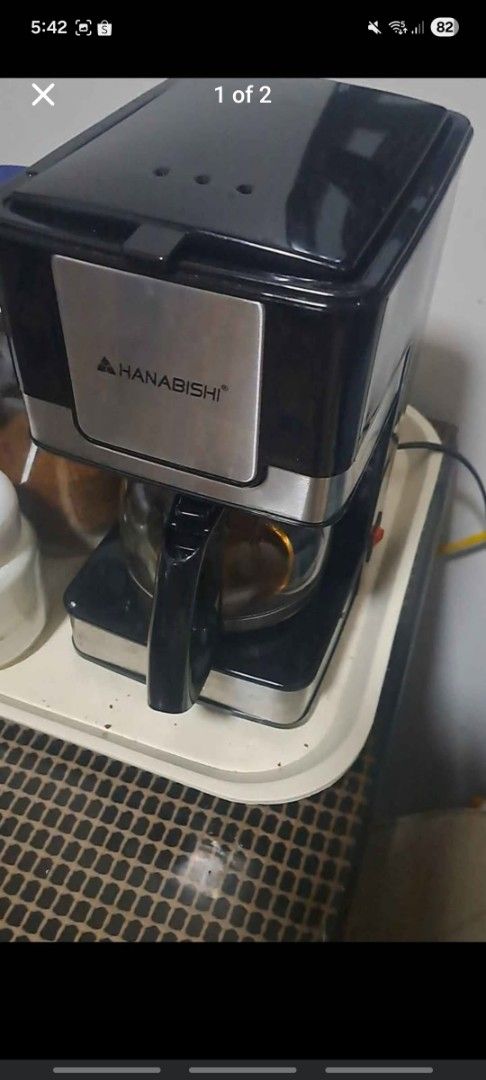 Hanabishi Coffee Maker with Glass Carafe (Category: Coffee Machines & Makers) located in Gapan. Submitted by smallfinds.ph (Listing ID 1469403824, Image 1). Description: may kasama pong kape. barako, excelda and robusta - Brand: Hanabishi - Color: Black and Silver - Includes: Glass pot with black handle and coffee: Barako, Robusta, Excelsa - Features: Side power switch and top lid with steam vents - Condition: Clean and ready for use - Perfect fo