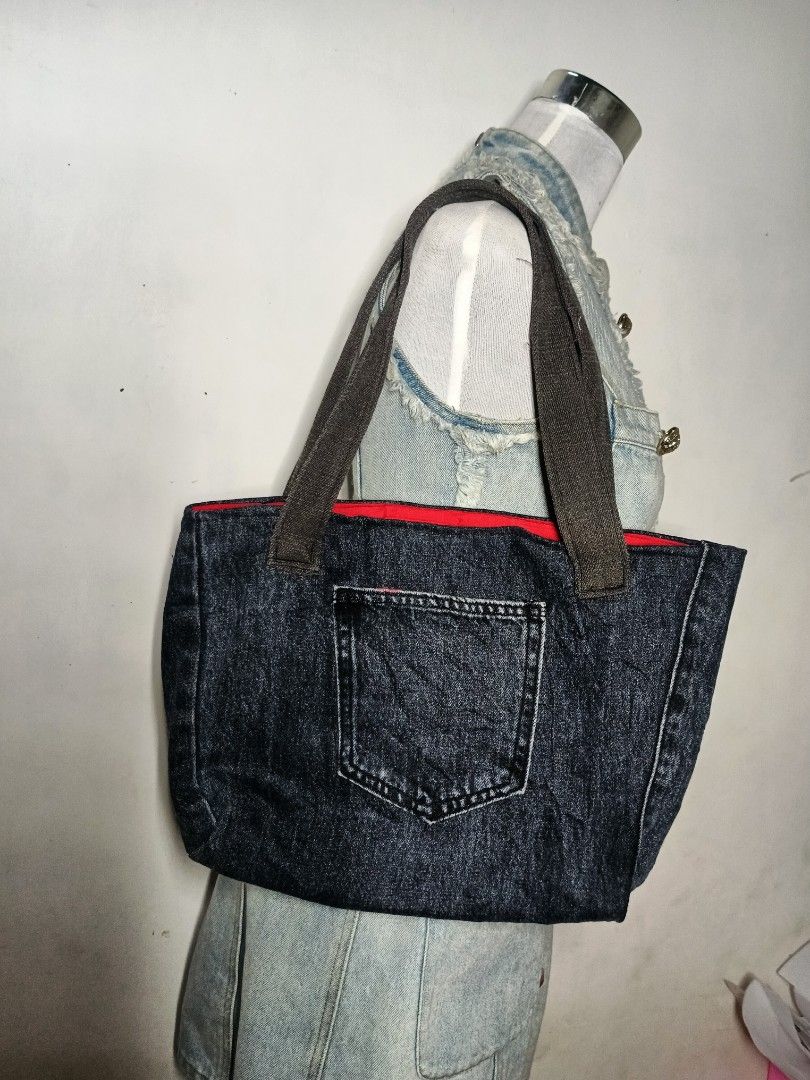 Handmade Denim Tote Bag with outer pocket (Category: Tote Bags) located in Manila. Submitted by danisadall (Listing ID 1469474103, Image 1). Description: - Dark denim material for a stylish, casual look - Sturdy brown shoulder straps for comfortable carrying - Convenient front outer pocket for quick-access items - Vibrant red fabric interior lining for a pop of color - Practical size ideal for daily errands, school, or work.