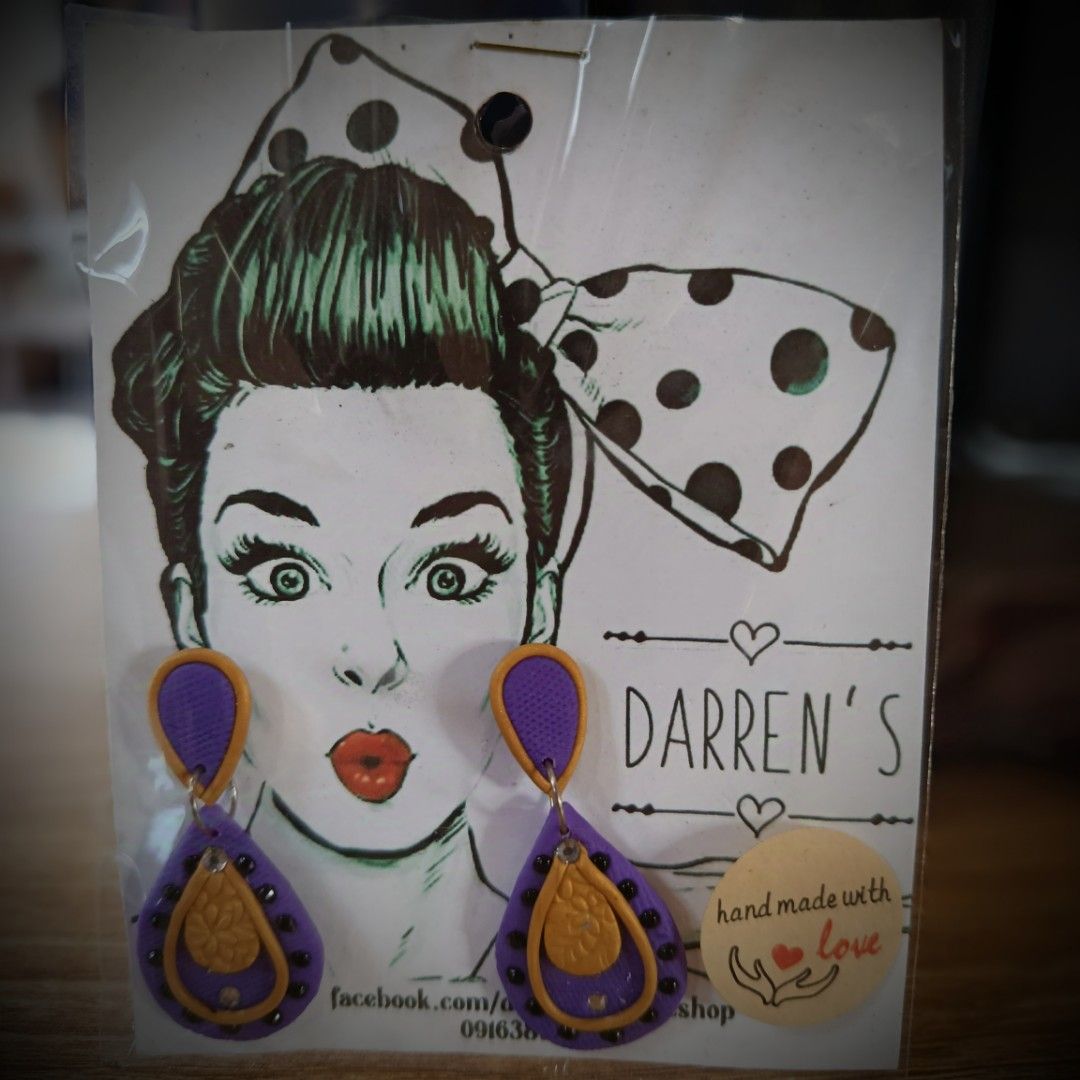 HANDMADE POLYMER CLAY DANGLING EARRINGS (Category: Earrings) located in San Pedro. Submitted by abieboink (Listing ID 1469440841, Image 3). Description: - Brand: Darren's - Product: Handmade polymer clay dangling earrings - Design: Blue and black teardrop pattern with intricate bead details - Condition: Brand new, packaged with backing card - Features: Lightweight, unique artisan style .