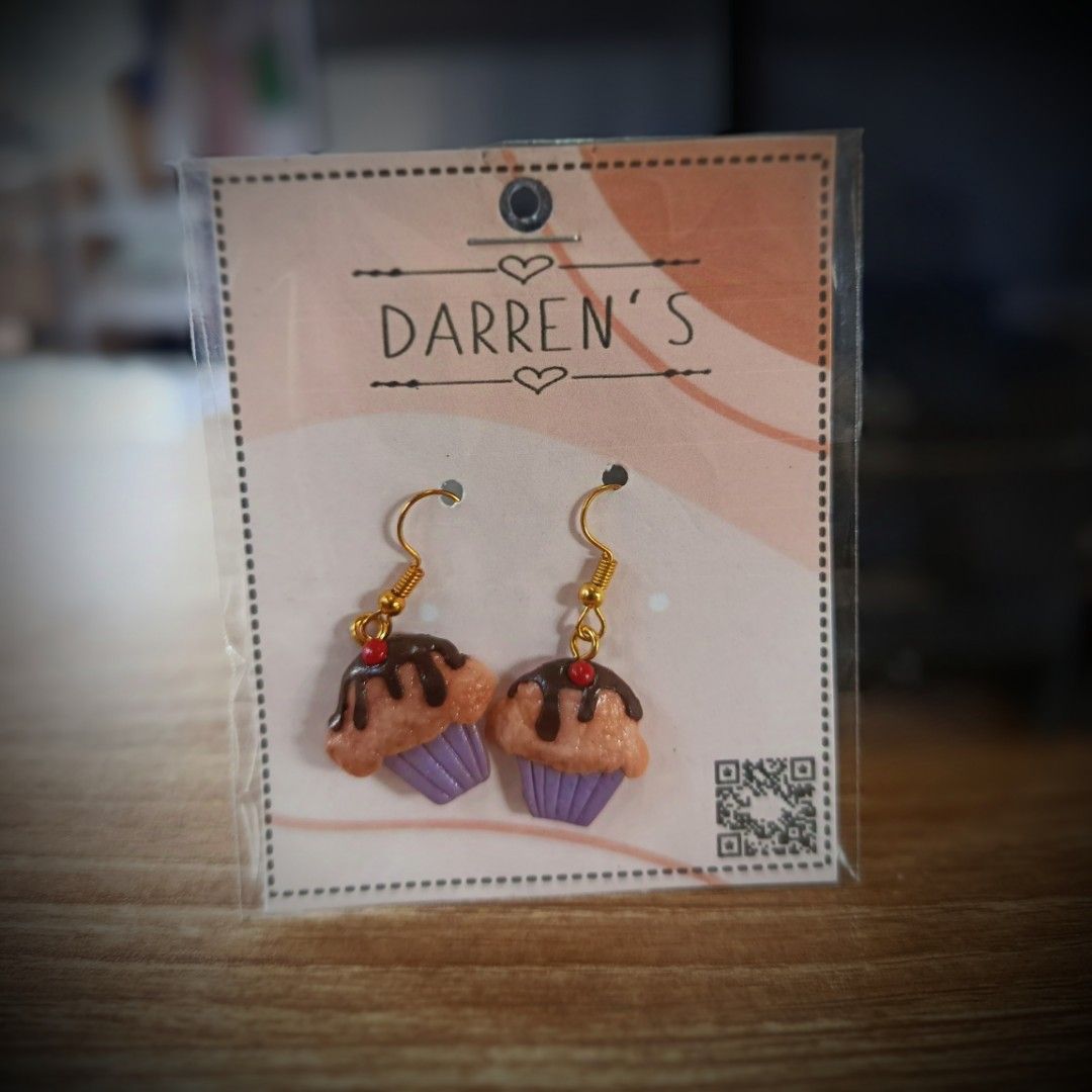 HANDMADE POLYMER CLAY, RESIN, BEADS EARRINGS (Category: Earrings) located in San Pedro. Submitted by abieboink (Listing ID 1469442836, Image 1). Description: - Brand: Darren's - Material: Handmade polymer clay with gold-toned hooks - Design: Adorable mini cupcakes with chocolate drizzle, red cherry detail, and purple liners, flowers, bows, bear, glow in the dark dice, - Condition: Brand new in original packaging - Perfect for daily wear, gifts, o