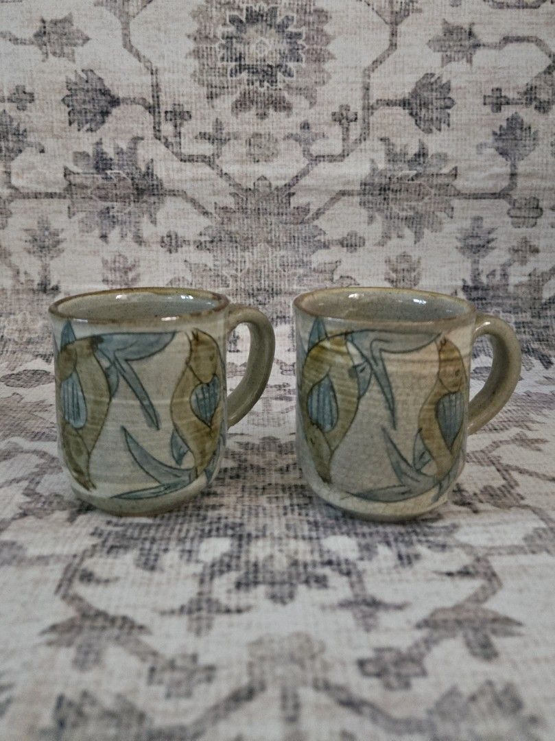 Handpainted ceramic cups bundle set (2pcs) (Category: Coffee & Tea Tableware) located in Manila. Submitted by cwknds (Listing ID 1469485850, Image 1). Description: pair of handthrown cups. detailed with fluid, handpainted fish artwork across an unrefined cream and sage stoneware body. • 7.5 x 6.5 cm • potter's mark ~ personally sourced&curated.