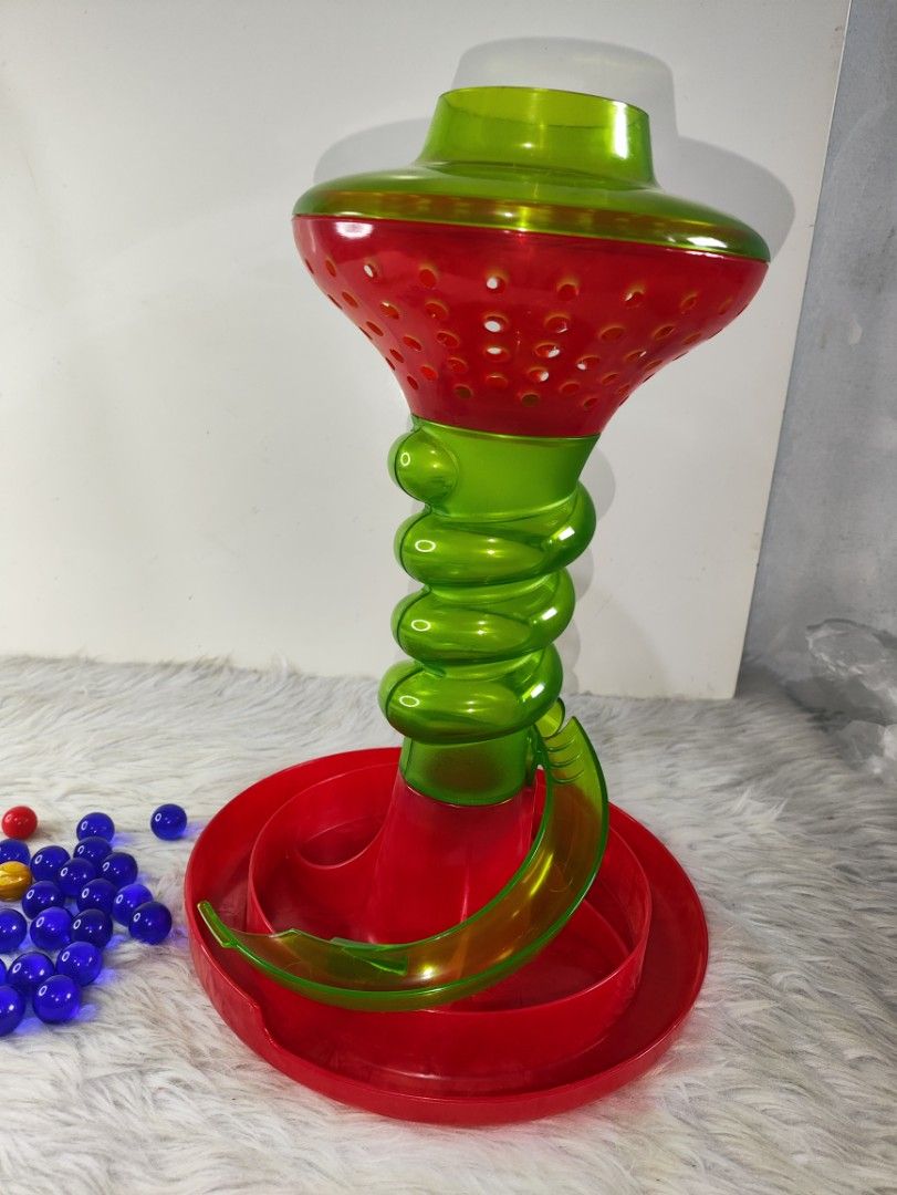 Hasbro KerPlunk Game with Box and Pieces (Category: Board Games & Puzzles) located in Cavite. Submitted by tinetaclesss (Listing ID 1469508664, Image 3). Description: - Classic KerPlunk action game by Hasbro - Includes green and red plastic tower, base, colorful sticks, and multiple blue marbles - Comes with original box (shows minor wear) - Perfect for family game nights, gatherings, and kids' parties - Complete set, clean, and 100% ready to pla