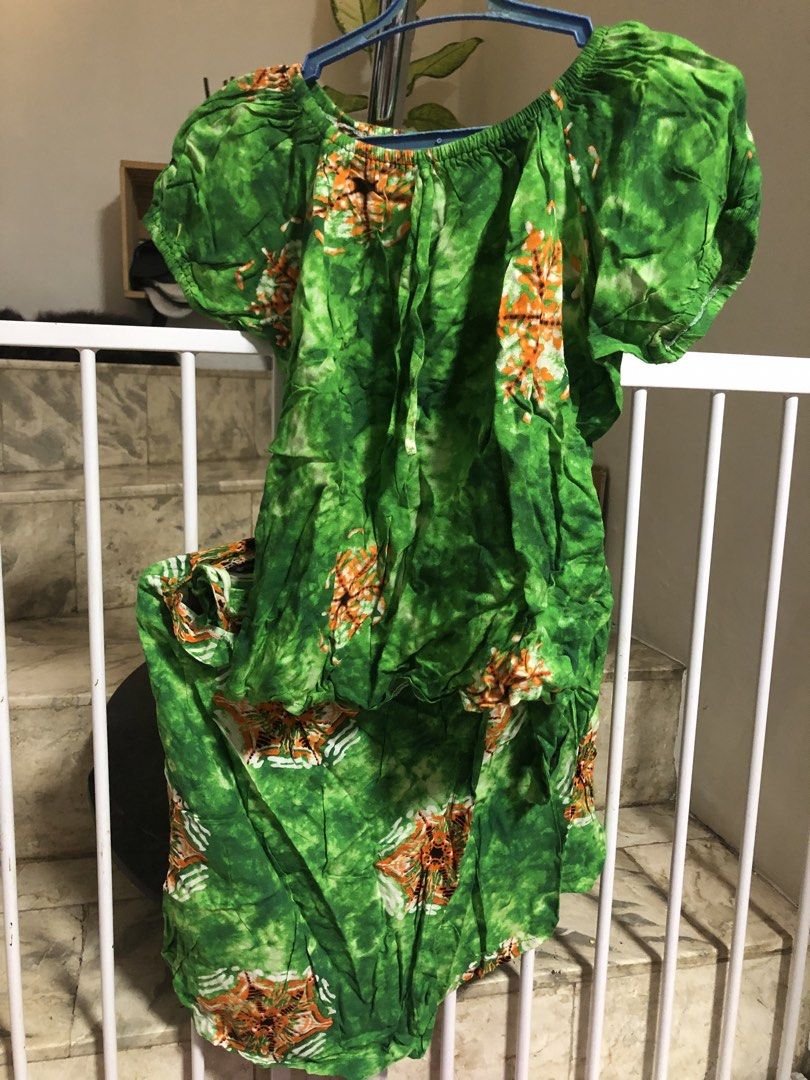 Hawaiian Off Shoulder Dress (Category: Babies & Kids Fashion) located in Paranaque City. Submitted by adellistuff (Listing ID 1469439880, Image 1). Description: - Style: Off-shoulder tropical dress - Pattern: Green and white tie-dye with orange floral motifs - Details: Elastic off-shoulder neckline, short puff sleeves, and front drawstring tie - Fabric: Lightweight and breathable, perfect for summer.