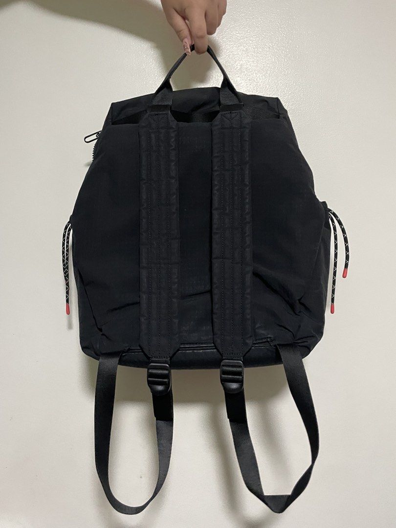 Hedgren Black Backpack with Drawstring Accents (Category: Backpacks) located in Mandaluyong City. Submitted by elmo_7 (Listing ID 1469407732, Image 2). Description: - Brand: Hedgren - Color: Classic Black - Material: Durable fabric with sturdy back straps - Closure: Dual zippers for the main compartment - Details: Trendy drawstrings with pink tips, subtle embossed logo, and front ring attachment - Condition: Clean interior and exterior with only 