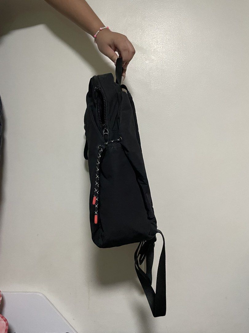 Hedgren Black Backpack with Drawstring Accents (Category: Backpacks) located in Mandaluyong City. Submitted by elmo_7 (Listing ID 1469407732, Image 3). Description: - Brand: Hedgren - Color: Classic Black - Material: Durable fabric with sturdy back straps - Closure: Dual zippers for the main compartment - Details: Trendy drawstrings with pink tips, subtle embossed logo, and front ring attachment - Condition: Clean interior and exterior with only 