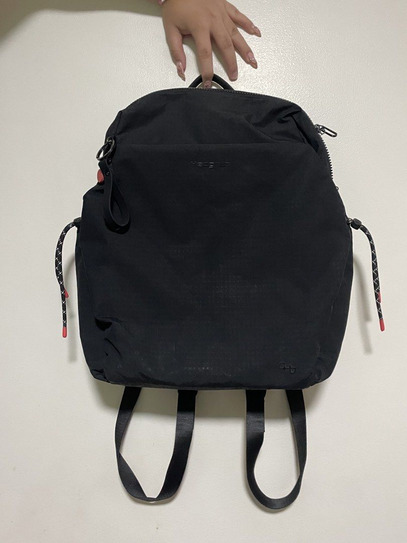 Hedgren Black Backpack with Drawstring Accents (Category: Backpacks) located in Mandaluyong City. Submitted by elmo_7 (Listing ID 1469407732, Image 1). Description: - Brand: Hedgren - Color: Classic Black - Material: Durable fabric with sturdy back straps - Closure: Dual zippers for the main compartment - Details: Trendy drawstrings with pink tips, subtle embossed logo, and front ring attachment - Condition: Clean interior and exterior with only 