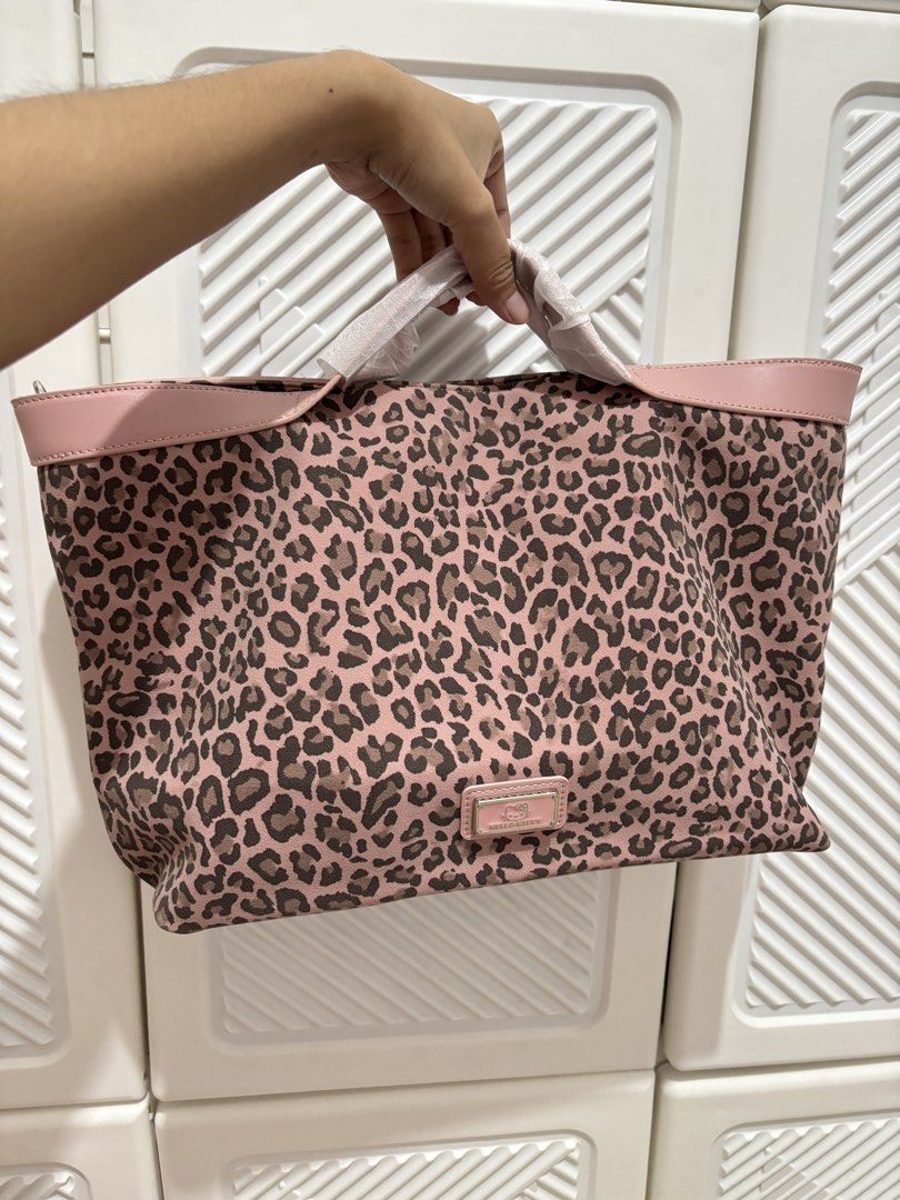 Hello Kitty/ HK Pink Leopard Shoulder Bag (Category: Shoulder Bags) located in Mandaluyong City. Submitted by itspink_lacey (Listing ID 1469396241, Image 1). Description: Brandnew Hello Kitty Leopard Shoulder bag (medium size) Can be used as hand bag Sling is removeable Invisible magnetic snap closure Can fit 13inch laptop With free small zippered pouch (can be used a small sling bag too).