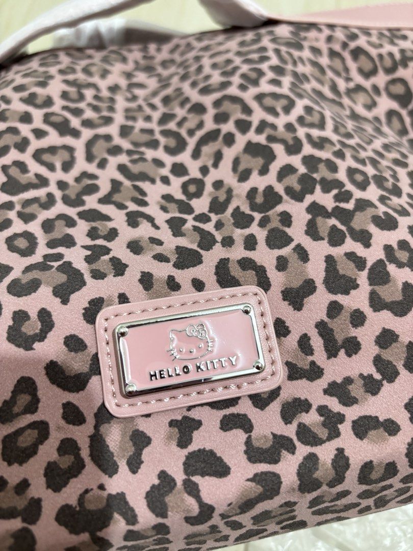 Hello Kitty/ HK Pink Leopard Shoulder Bag (Category: Shoulder Bags) located in Mandaluyong City. Submitted by itspink_lacey (Listing ID 1469396241, Image 3). Description: Brandnew Hello Kitty Leopard Shoulder bag (medium size) Can be used as hand bag Sling is removeable Invisible magnetic snap closure Can fit 13inch laptop With free small zippered pouch (can be used a small sling bag too).