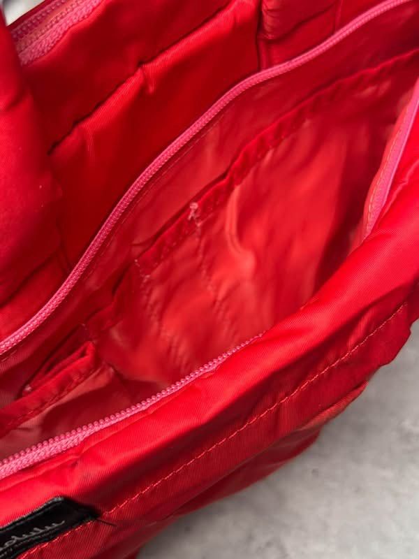 Hellolulu Red 13 inch Laptop Bag (Category: Laptop Bags & Sleeves) located in Baguio. Submitted by gokubusansan (Listing ID 1469560139, Image 2). Description: - Brand: Hellolulu - Color: Bright red - Fit: Comfortably fits up to a 13-inch laptop - Compartments: Padded inner compartment for laptop safety - Pockets: Zippered front pocket and interior pockets for chargers and mice - Handles: Convenient dual carry handles on top - There’s dirt on the 