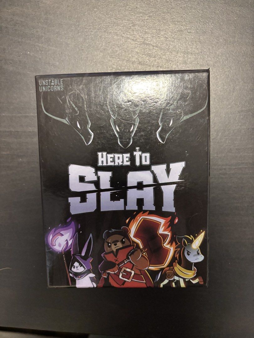 Here to Slay Strategy Card Game Unstable Unicorns (Category: Board Games & Puzzles) located in Manila. Submitted by mganovelo64040 (Listing ID 1469484767, Image 1). Description: Here to Slay strategic fantasy card game by the creators of Unstable Unicorns. Complete set including cards, two dice, and rule reference cards. Box opened to check contents only, never played..